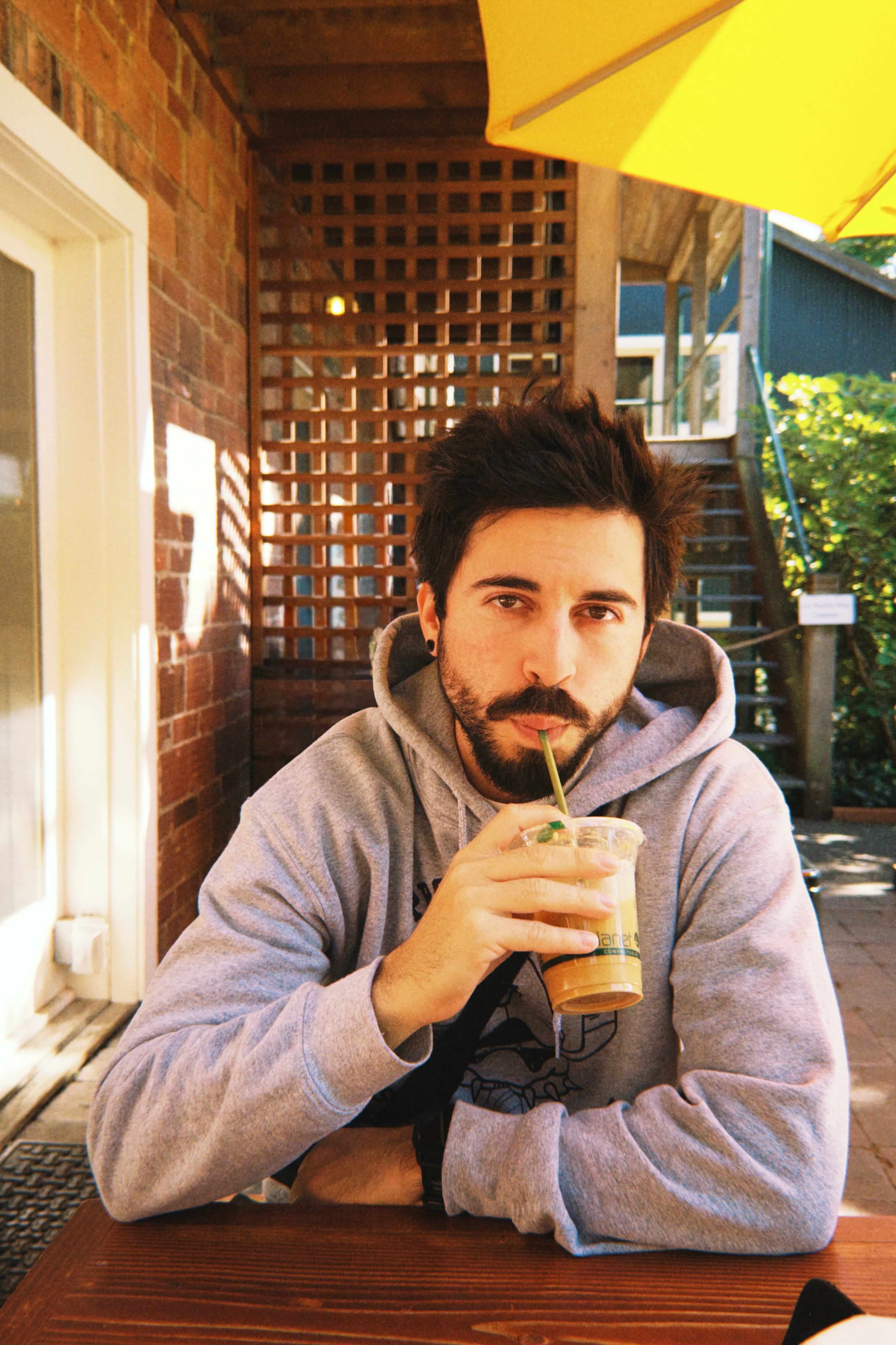 Daniel sipping coffee at an outdoor table